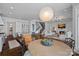 Open-concept kitchen and living area featuring a kitchen island, staircase, and cozy fireplace at 111 Moors End Loop, Mooresville, NC 28117