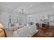 Open-concept living room with waterfront views, seamlessly connecting to the kitchen and dining area at 111 Moors End Loop, Mooresville, NC 28117