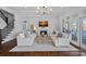 Elegant living room with fireplace, plush seating, coffered ceiling and access to outdoor living spaces at 111 Moors End Loop, Mooresville, NC 28117