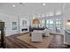 Inviting living room featuring a fireplace, water views, and neutral-toned furniture at 111 Moors End Loop, Mooresville, NC 28117