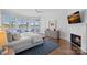 Tranquil main bedroom features waterfront views, a fireplace, and a calming color palette at 111 Moors End Loop, Mooresville, NC 28117