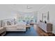 Serene main bedroom with large windows showcasing waterfront views and seating area with outside access at 111 Moors End Loop, Mooresville, NC 28117
