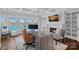 Bright home office with lake views, a fireplace, and built-in shelving at 111 Moors End Loop, Mooresville, NC 28117