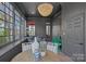 Cozy sunroom with lake views, adorned with stylish decor, a unique light fixture, and comfortable seating at 111 Moors End Loop, Mooresville, NC 28117