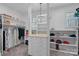 Bright walk-in closet with custom shelving, drawers, and a sparkling chandelier at 111 Moors End Loop, Mooresville, NC 28117