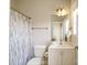 Bathroom featuring a shower with curtain, toilet, and a single sink vanity with a mirror at 1122 Dean Hall Ln, Matthews, NC 28105