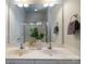 Bright bathroom with double sinks, a large mirror, and a shower with glass doors at 1122 Dean Hall Ln, Matthews, NC 28105