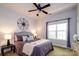 Comfortable bedroom featuring a ceiling fan, a window, a decorative compass, and neutral decor at 1122 Dean Hall Ln, Matthews, NC 28105