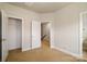 Empty bedroom with carpet and view into the closet, hallway, and bathroom at 1122 Dean Hall Ln, Matthews, NC 28105