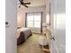 Cozy bedroom with a ceiling fan, a large window offering plenty of natural light, and plush carpet at 1122 Dean Hall Ln, Matthews, NC 28105
