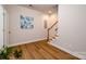 Bonus room with hardwood floors, wooden staircase, and a decorative print on the wall at 1122 Dean Hall Ln, Matthews, NC 28105