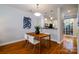 Dining area open to kitchen with wood table and modern light fixture at 1122 Dean Hall Ln, Matthews, NC 28105