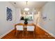 Bright dining room featuring hardwood floors, modern lighting, and open access to the adjacent kitchen at 1122 Dean Hall Ln, Matthews, NC 28105