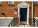 Townhome entrance showing black door with white pediment, and the unit number on the exterior brick at 1122 Dean Hall Ln, Matthews, NC 28105