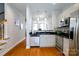 Bright kitchen with stainless steel appliances, granite countertops, and hardwood floors at 1122 Dean Hall Ln, Matthews, NC 28105