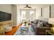 Cozy living room with hardwood floors, comfortable seating, and natural light from windows at 1122 Dean Hall Ln, Matthews, NC 28105