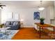 Open-concept living and dining area, featuring hardwood floors and neutral decor at 1122 Dean Hall Ln, Matthews, NC 28105