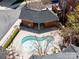 Aerial view of kidney-shaped pool area with red brick structure and tanning deck with lounge chairs at 1122 Dean Hall Ln, Matthews, NC 28105