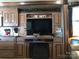 Living room features a large TV, fireplace, and built-in storage at 113 Larboard Trl # B36/37, Mount Gilead, NC 27306