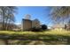Spacious backyard featuring a deck, fenced-in area, and second building at 1134 Riverside Dr, Charlotte, NC 28214