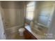 Neutral bathroom features a shower-tub combo with decorative fixtures at 1134 Riverside Dr, Charlotte, NC 28214