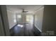 A bedroom featuring wood floors, large windows, and white trim at 1134 Riverside Dr, Charlotte, NC 28214