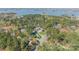 Aerial of a sprawling property showcases the large home, lush landscaping, and pool at 115 Stonewall Beach Ln, Mooresville, NC 28117
