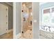 An elegant bathroom showcases a glass-enclosed shower with a built-in bench at 115 Stonewall Beach Ln, Mooresville, NC 28117