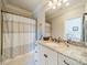 Clean bathroom featuring a granite countertop and patterned shower curtain for a neat look at 115 Stonewall Beach Ln, Mooresville, NC 28117