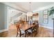 Elegant dining room with wood table, chandelier, and ample natural light at 115 Stonewall Beach Ln, Mooresville, NC 28117