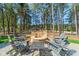 Outdoor fire pit and chairs providing a welcoming space to unwind near the tall trees at 115 Stonewall Beach Ln, Mooresville, NC 28117