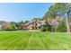 Charming home featuring a manicured lawn, mature trees, and a circular driveway at 115 Stonewall Beach Ln, Mooresville, NC 28117