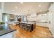 Bright kitchen featuring a large center island, white cabinetry, and stainless steel appliances at 115 Stonewall Beach Ln, Mooresville, NC 28117