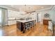 A modern kitchen with a large island, seating, and pendant lighting at 115 Stonewall Beach Ln, Mooresville, NC 28117