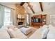 Bright living room featuring a stone fireplace, built-in shelving, and comfortable seating at 115 Stonewall Beach Ln, Mooresville, NC 28117