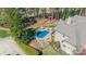 Aerial view showcasing a sparkling blue in-ground pool with a spa and an outdoor fireplace at 115 Stonewall Beach Ln, Mooresville, NC 28117
