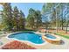 Inviting backyard pool and hot tub offering a private outdoor retreat surrounded by mature trees at 115 Stonewall Beach Ln, Mooresville, NC 28117