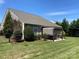 Beautifully landscaped backyard featuring a covered patio and lush green lawn at 116 Water Ski Dr, Statesville, NC 28677