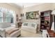 Comfortable bedroom with a soft sofa, bookshelf, and window at 116 Water Ski Dr, Statesville, NC 28677
