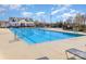 Community swimming pool on a sunny day with lounge chairs at 116 Water Ski Dr, Statesville, NC 28677
