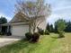 Exterior view of home and landscaped yard with beautiful shrubbery and well maintained lawn at 116 Water Ski Dr, Statesville, NC 28677