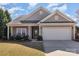 Charming single-story home with neutral siding, attached garage, well-kept lawn, and covered front porch at 116 Water Ski Dr, Statesville, NC 28677