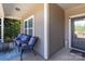 Comfortable covered front porch with seating area including patio chairs with blue cushions and a blue rug at 116 Water Ski Dr, Statesville, NC 28677