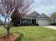 Charming one-story home featuring a well-maintained lawn, tidy landscaping, and a welcoming front porch at 116 Water Ski Dr, Statesville, NC 28677