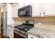 Close up shot of stainless steel gas range and granite countertops in kitchen at 116 Water Ski Dr, Statesville, NC 28677