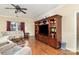 Comfortable living room featuring hardwood floors, a built-in entertainment center, and lots of natural light at 116 Water Ski Dr, Statesville, NC 28677