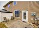 Cozy back patio with neutral-toned siding, seating, and a door leading inside at 1211 Croft Dr, Fort Mill, SC 29708