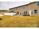 Expansive backyard featuring green grass, a white fence, and a cozy patio at 1211 Croft Dr, Fort Mill, SC 29708