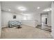 Basement seating area with carpet flooring, blue couch, and a small table at 1211 Croft Dr, Fort Mill, SC 29708