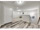 Basement entrance with grey wood floors and door leading to the finished room at 1211 Croft Dr, Fort Mill, SC 29708